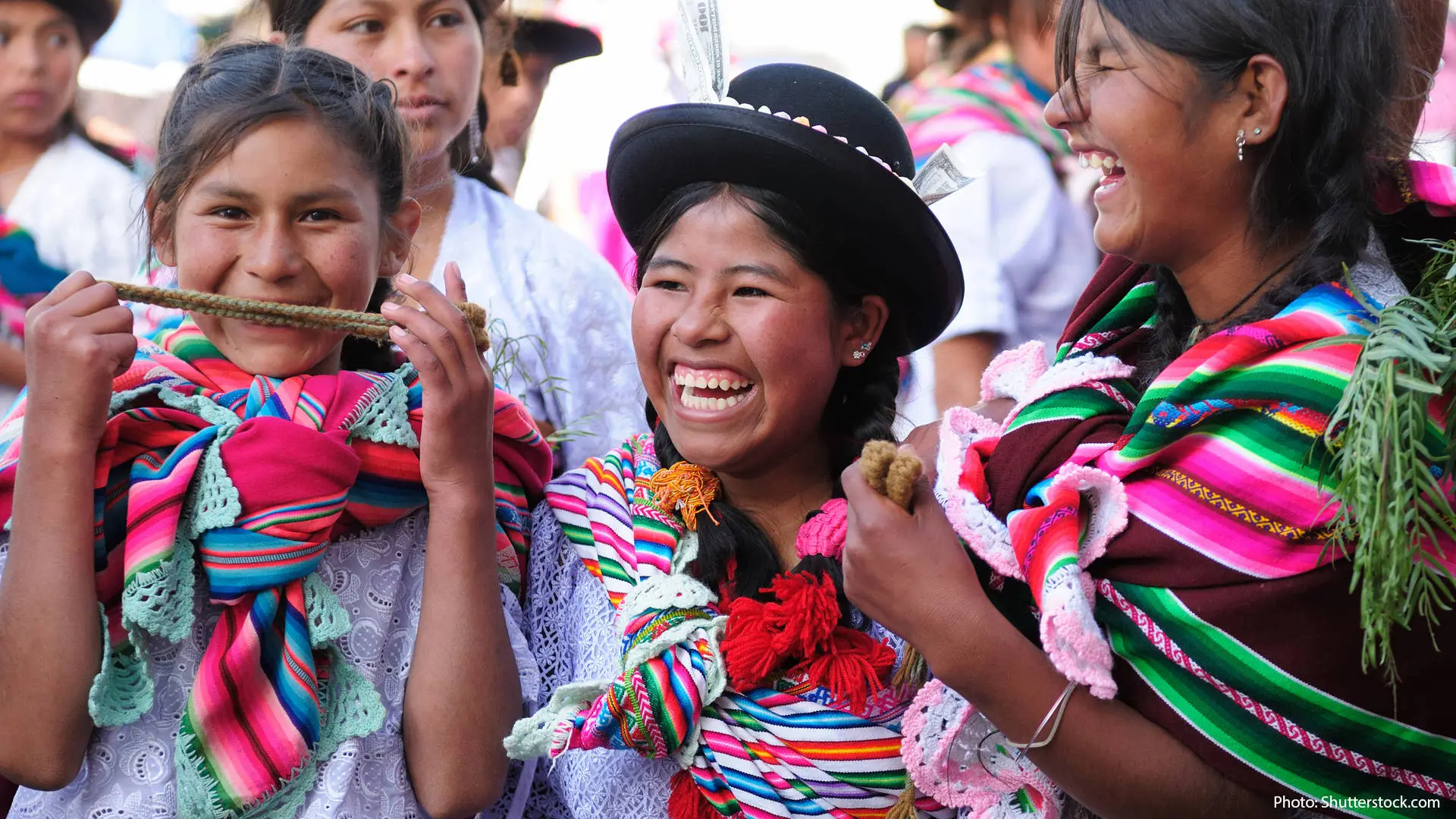Women in traditional clothing at a celebration in Bolivia
